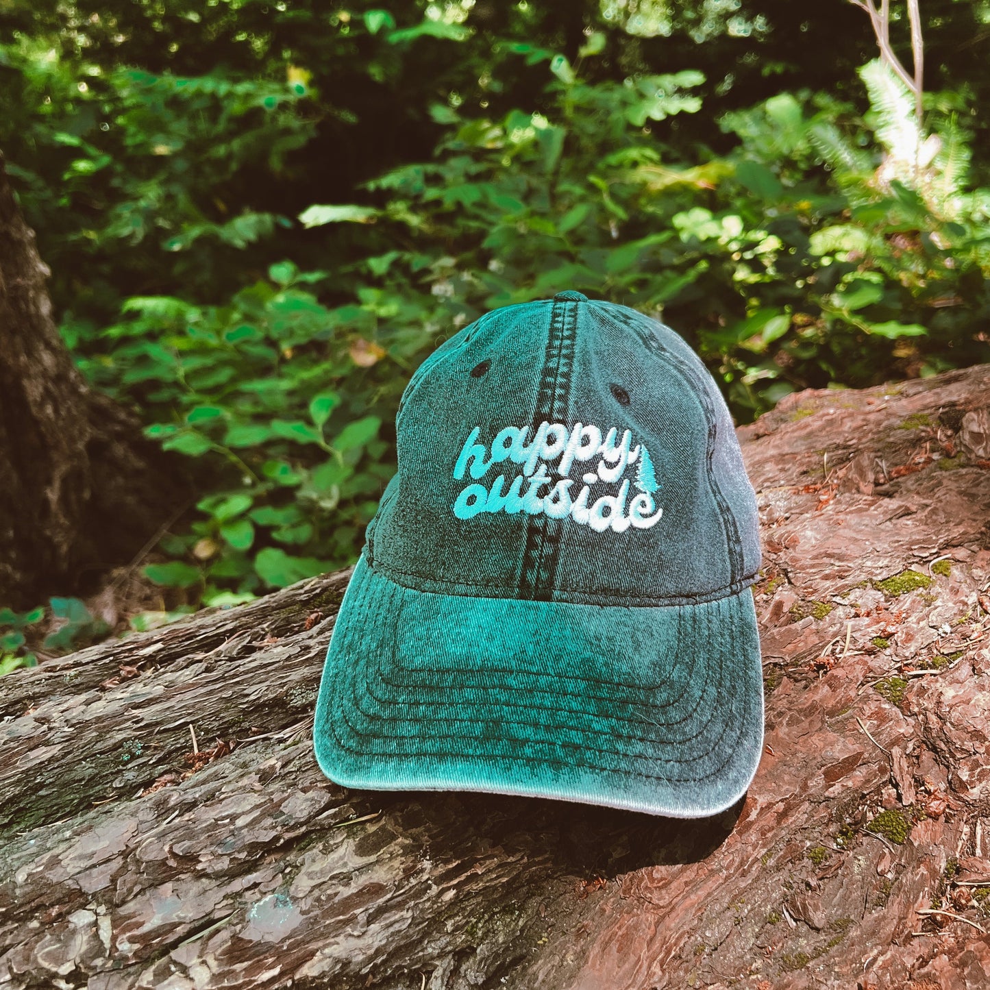 gray denim hat with the words "happy outside" on the hat