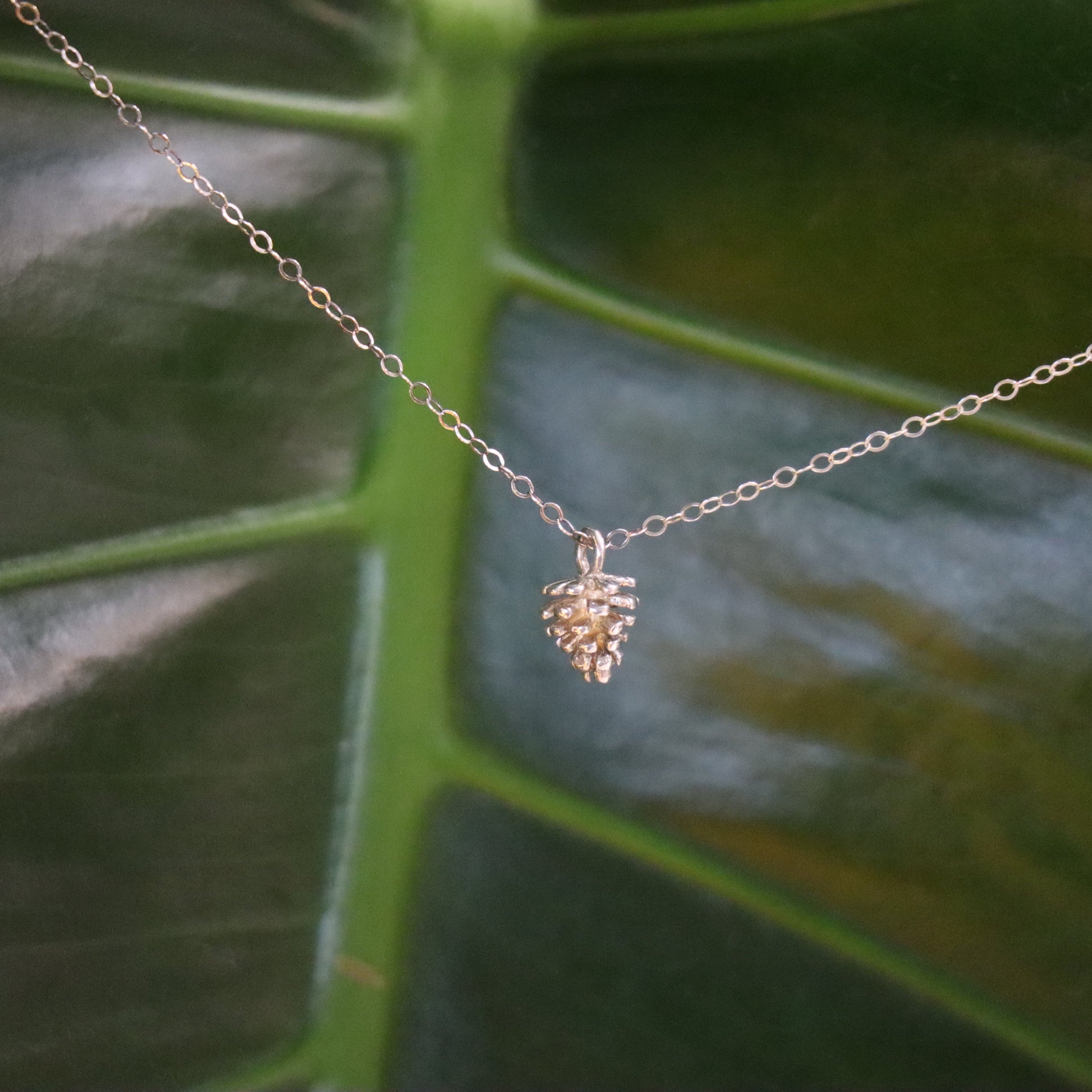 Silver necklace with pinecone charm