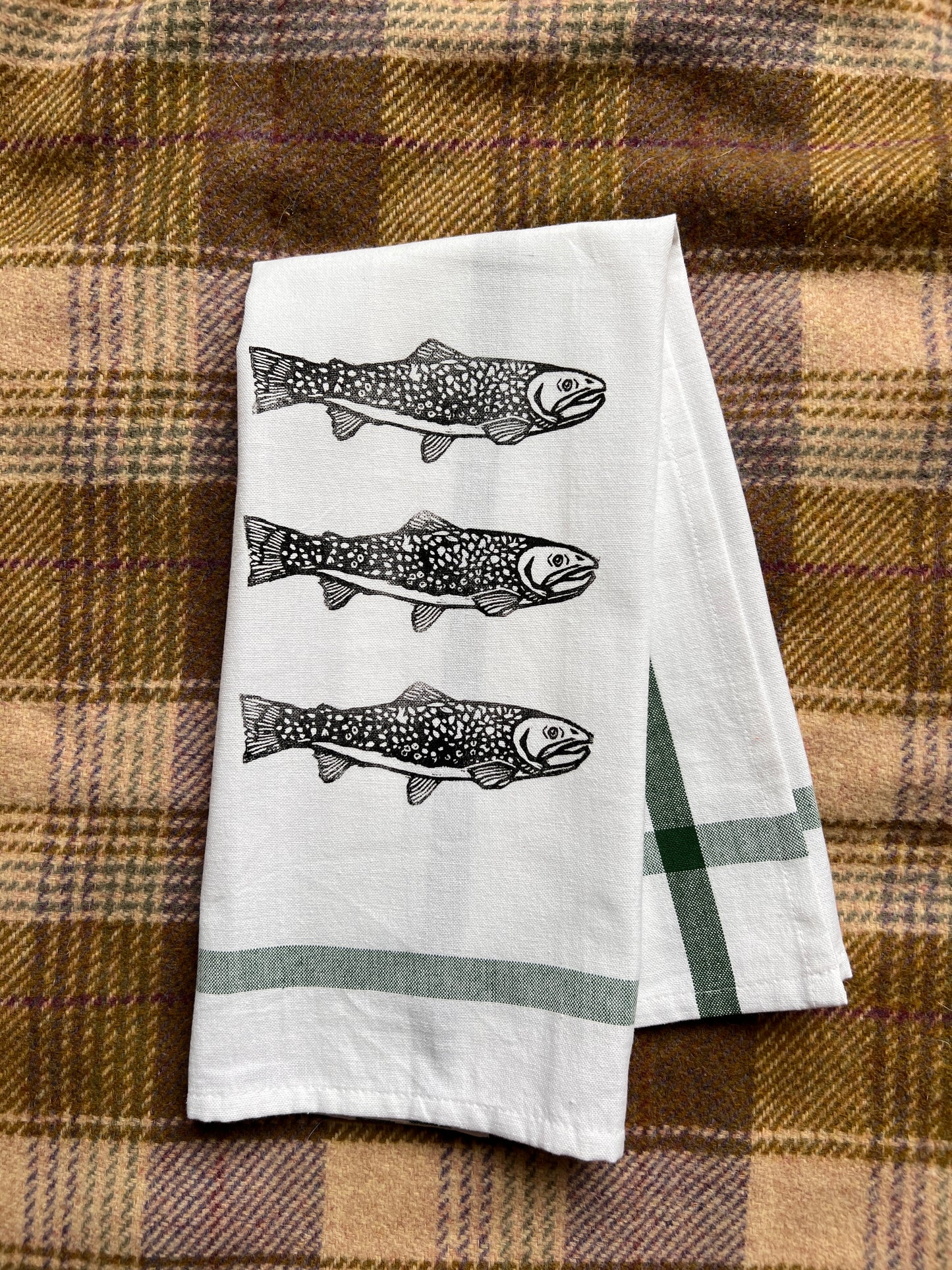  tea towel with fish design on a plaid fabric background