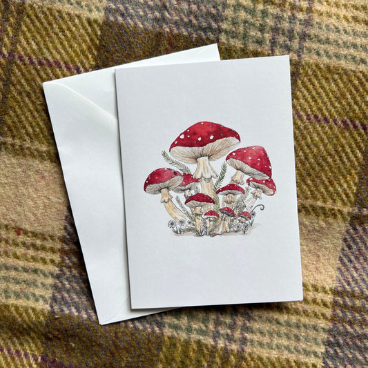 Greeting card with mushroom design on a plaid fabric background