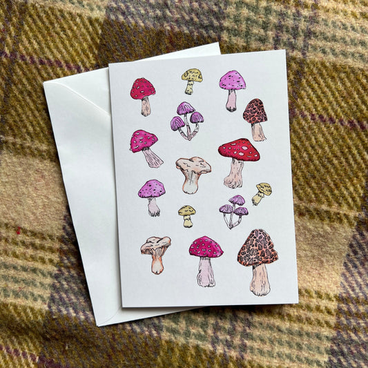 Greeting card with mushroom illustrations on a plaid fabric background